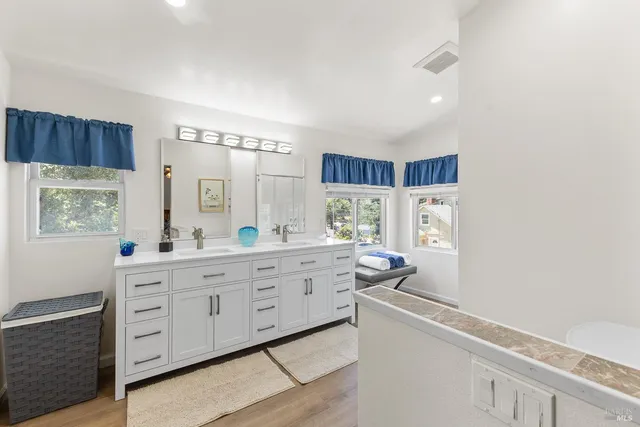 a room with painting on the wall and a window