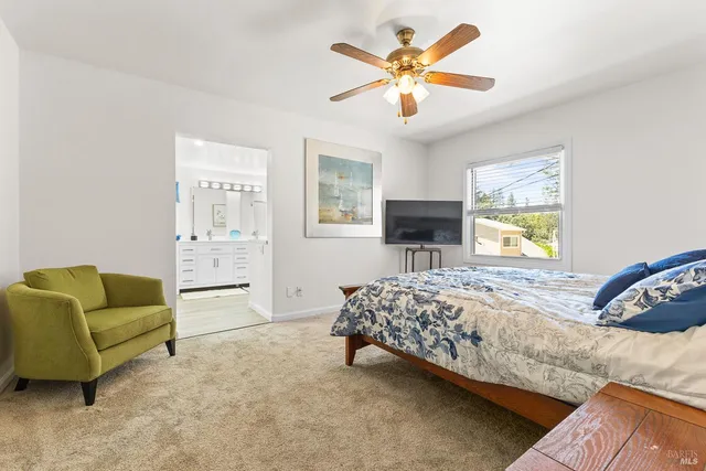 a bedroom with a bed couch and window
