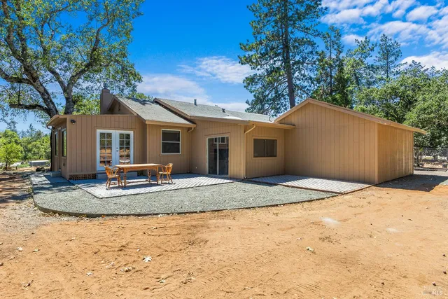 a view of a house with entertaining space and a tree