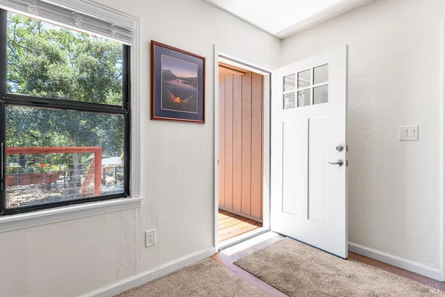 an empty room with windows and closet