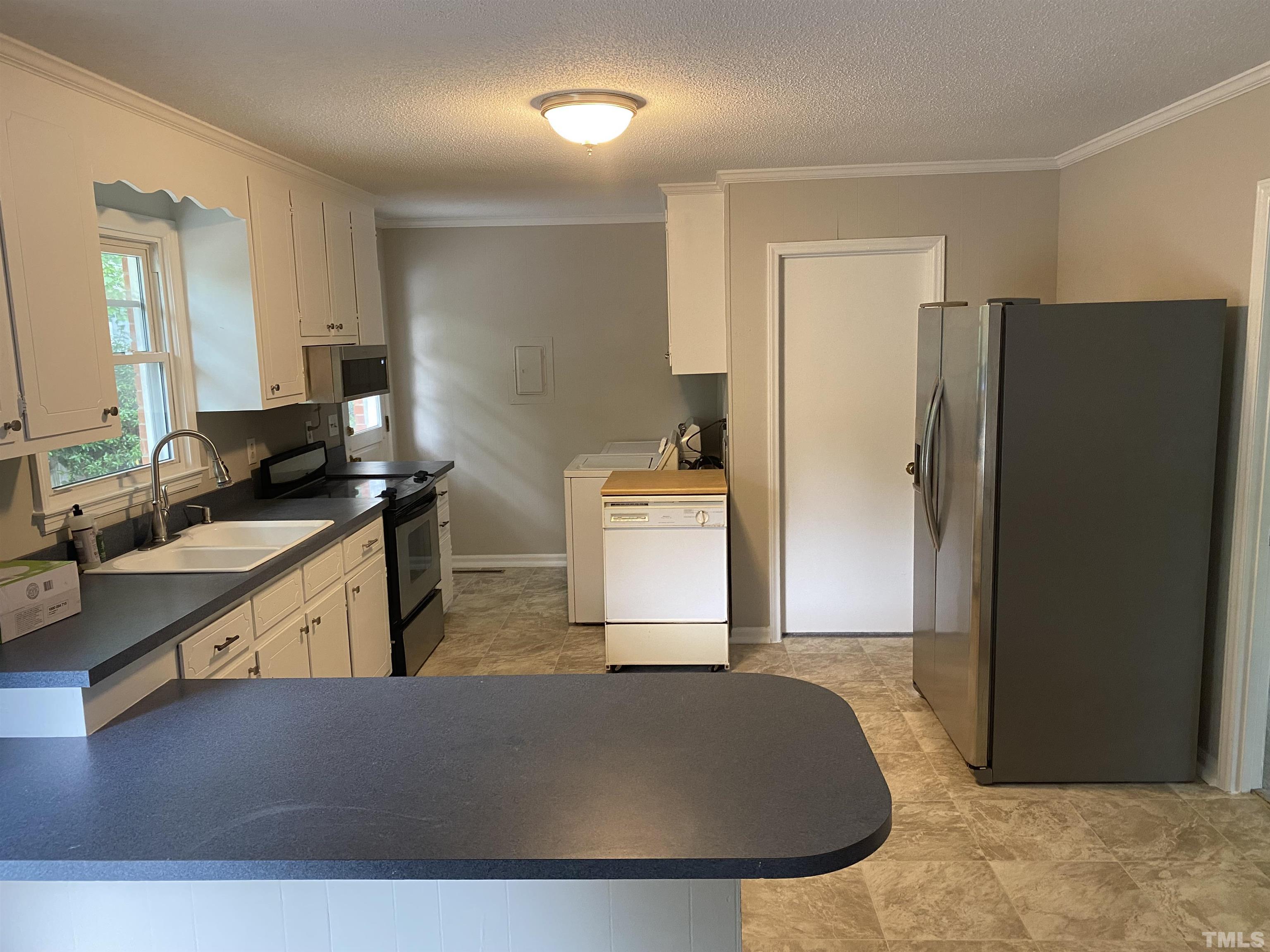 4903 Mandel Road Durham, NC 27712 - Photo 7 of 21 Spacious kitchen with plenty of cupboard space. All appliance convey. New flooring.
