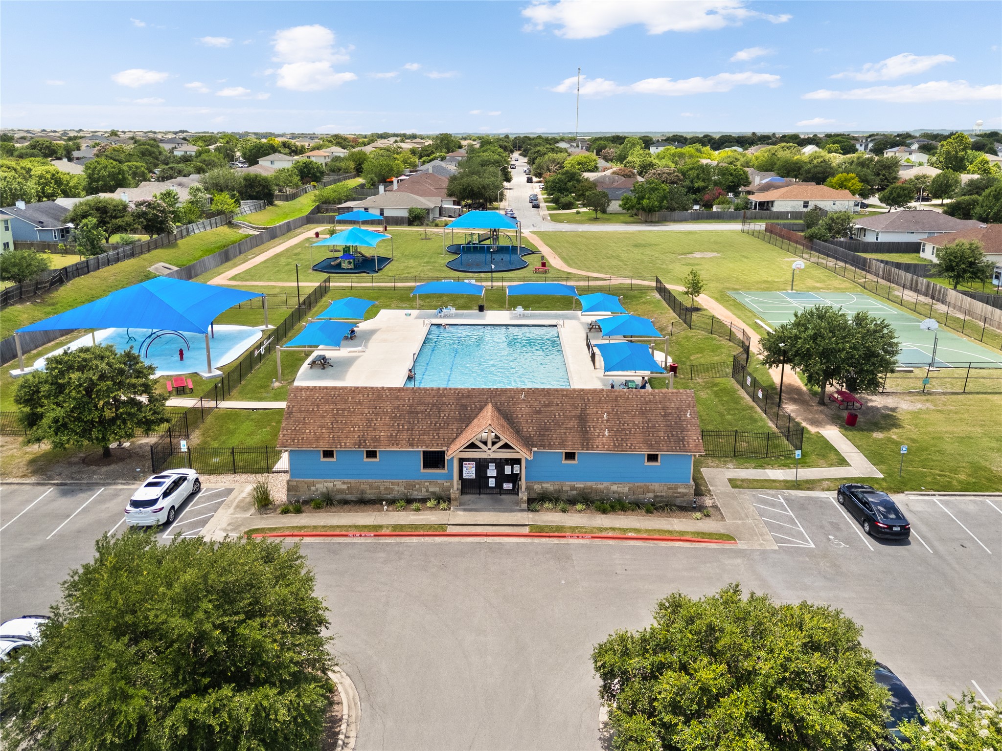 256 Alpha Kyle, TX 78640 - Photo 24 of 27 A vibrant community hub featuring a pristine pool, inviting playground, and courts for active recreation.