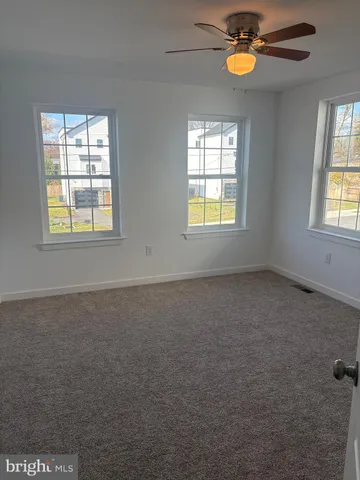 an empty room with windows and closet