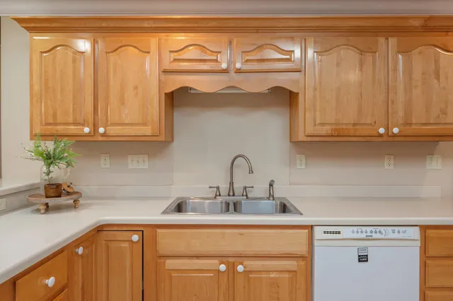 a kitchen with stainless steel appliances granite countertop a refrigerator and a stove