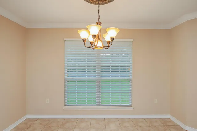 a kitchen with stainless steel appliances granite countertop a sink a stove top oven a chimney and a window