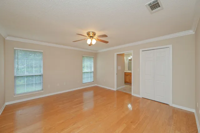a bedroom with a bed lamp and a potted plant