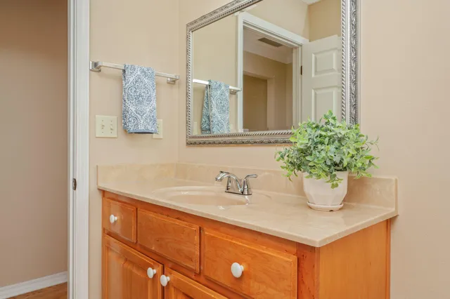 a bedroom with furniture and a chandelier fan