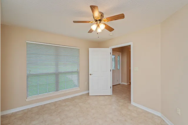 a view of a livingroom with a chandelier fan