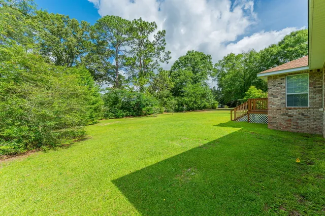 a view of a lake with a yard and trees