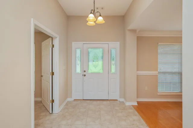 a dining room with furniture and chandelier