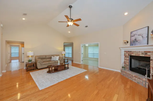 a living room with furniture and wooden floor