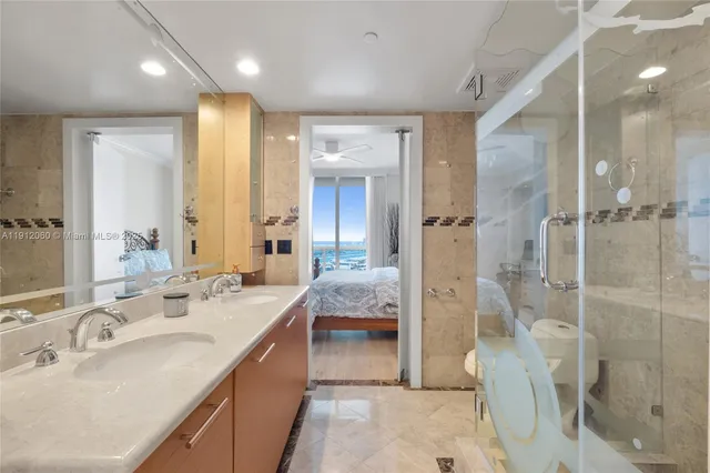 a bathroom with a double vanity sink mirror and shower
