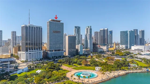 a view of a balcony with chairs and iron fence