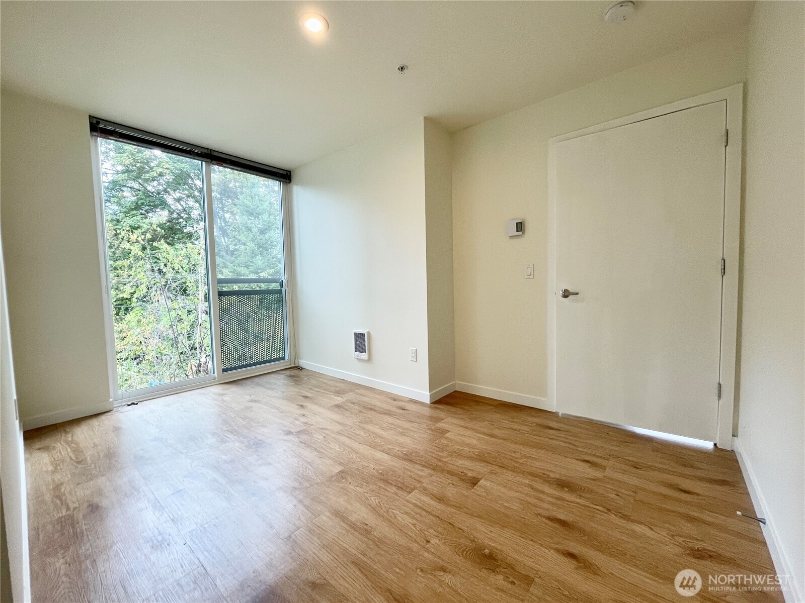 2249 Northeast 46th Street Seattle, WA 98105 - Photo 13 of 20 a view of an empty room with wooden floor and a window