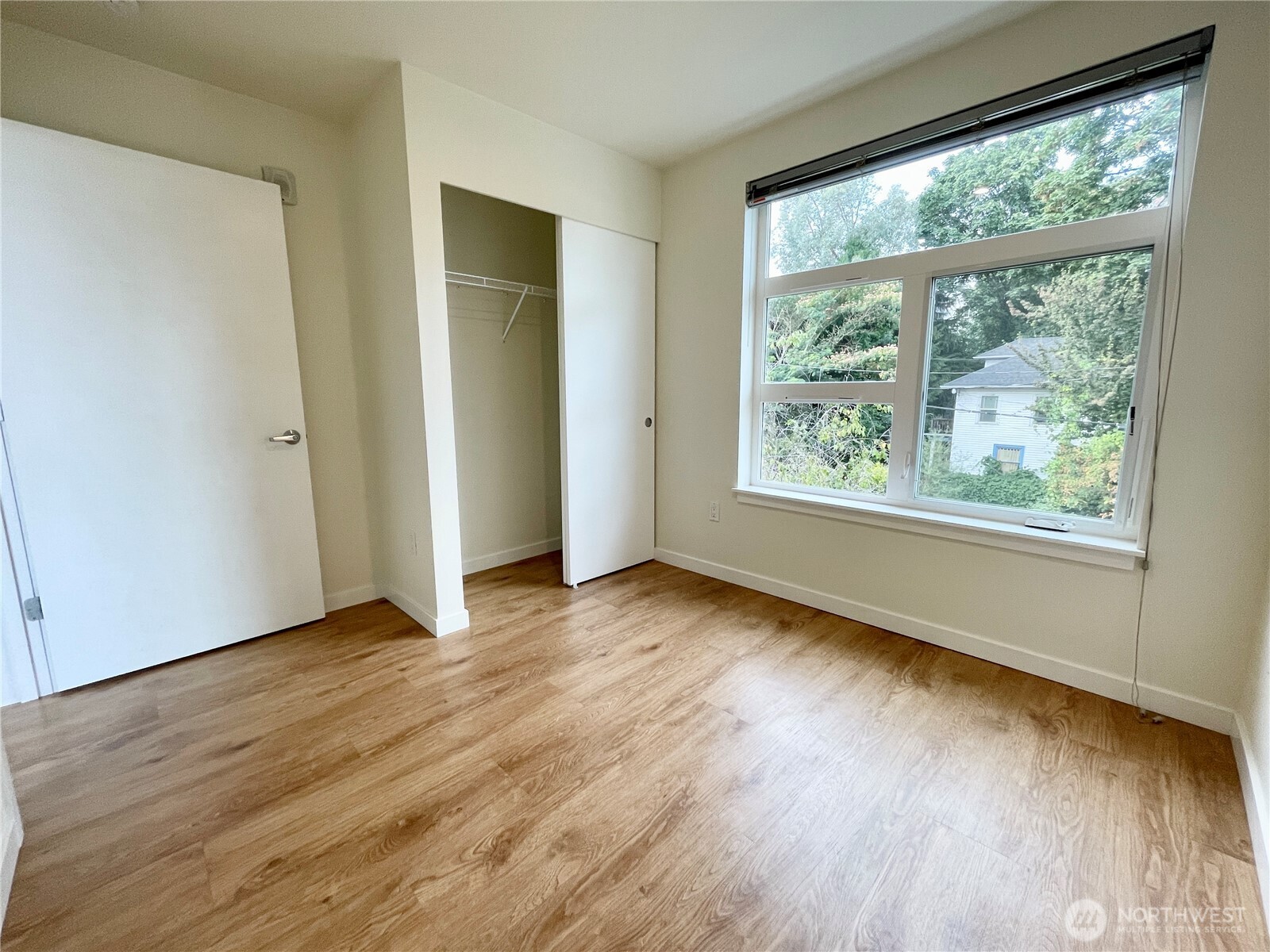 2249 Northeast 46th Street Seattle, WA 98105 - Photo 14 of 20 a view of an empty room and wooden floor and window