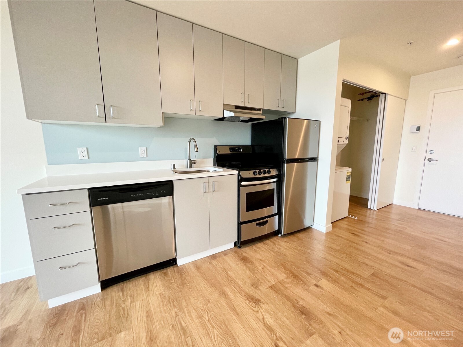 2249 Northeast 46th Street Seattle, WA 98105 - Photo 16 of 20 a kitchen with a sink cabinets stainless steel appliances and a window