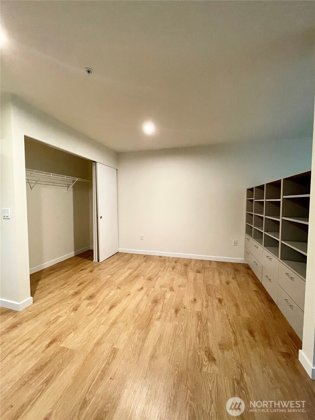 2249 Northeast 46th Street Seattle, WA 98105 - Photo 8 of 20 a view of an empty room with wooden floor and windows