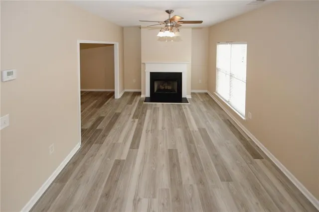 wooden floor in an empty room with a window
