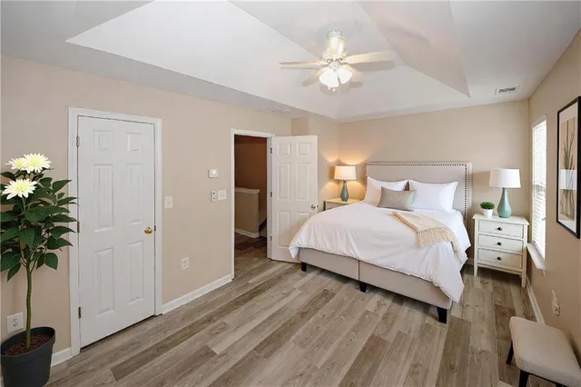 a spacious bedroom with a bed and a chandelier