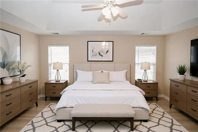 a bedroom with a bed and a chandelier