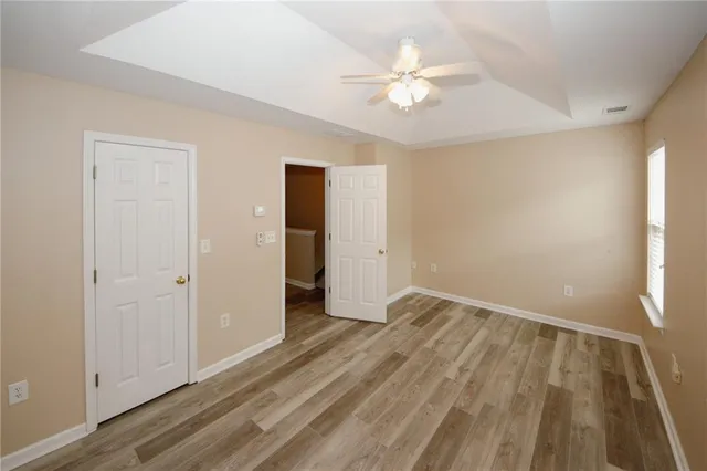 a view of an empty room with wooden floor