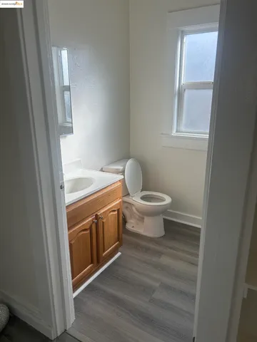 a bathroom with a granite countertop toilet and a sink
