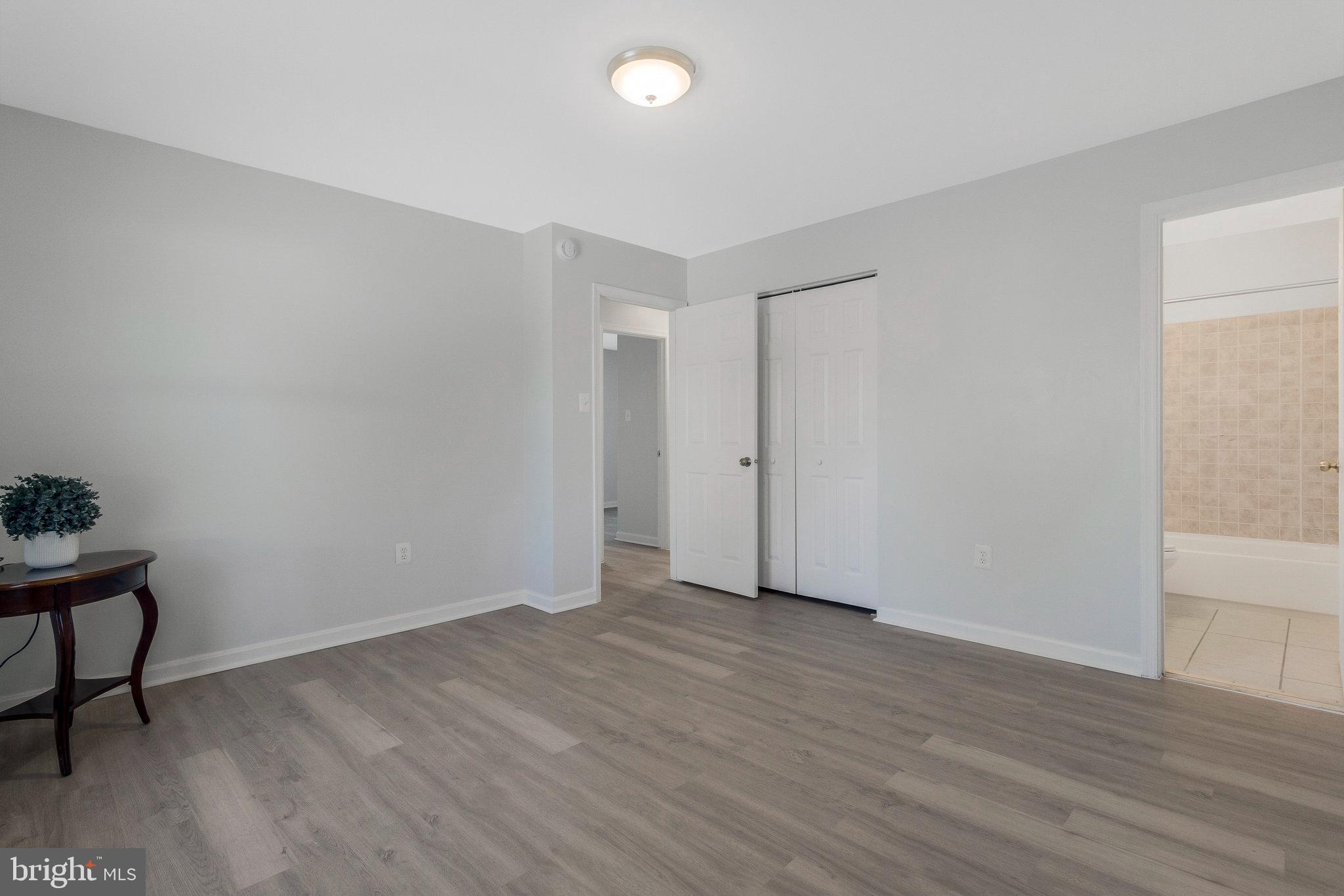 5004 Roanoke Place College Park, MD 20740 - Photo 11 of 27 a view of an empty room with wooden floor and a window