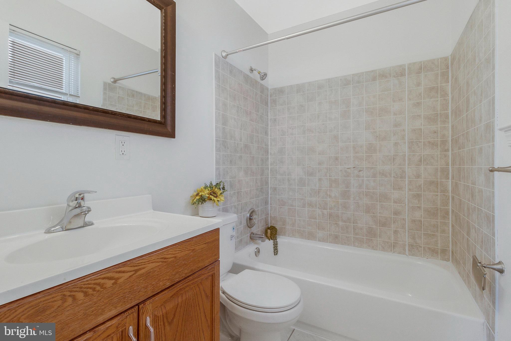 5004 Roanoke Place College Park, MD 20740 - Photo 12 of 27 a bathroom with a sink a toilet and a bathtub