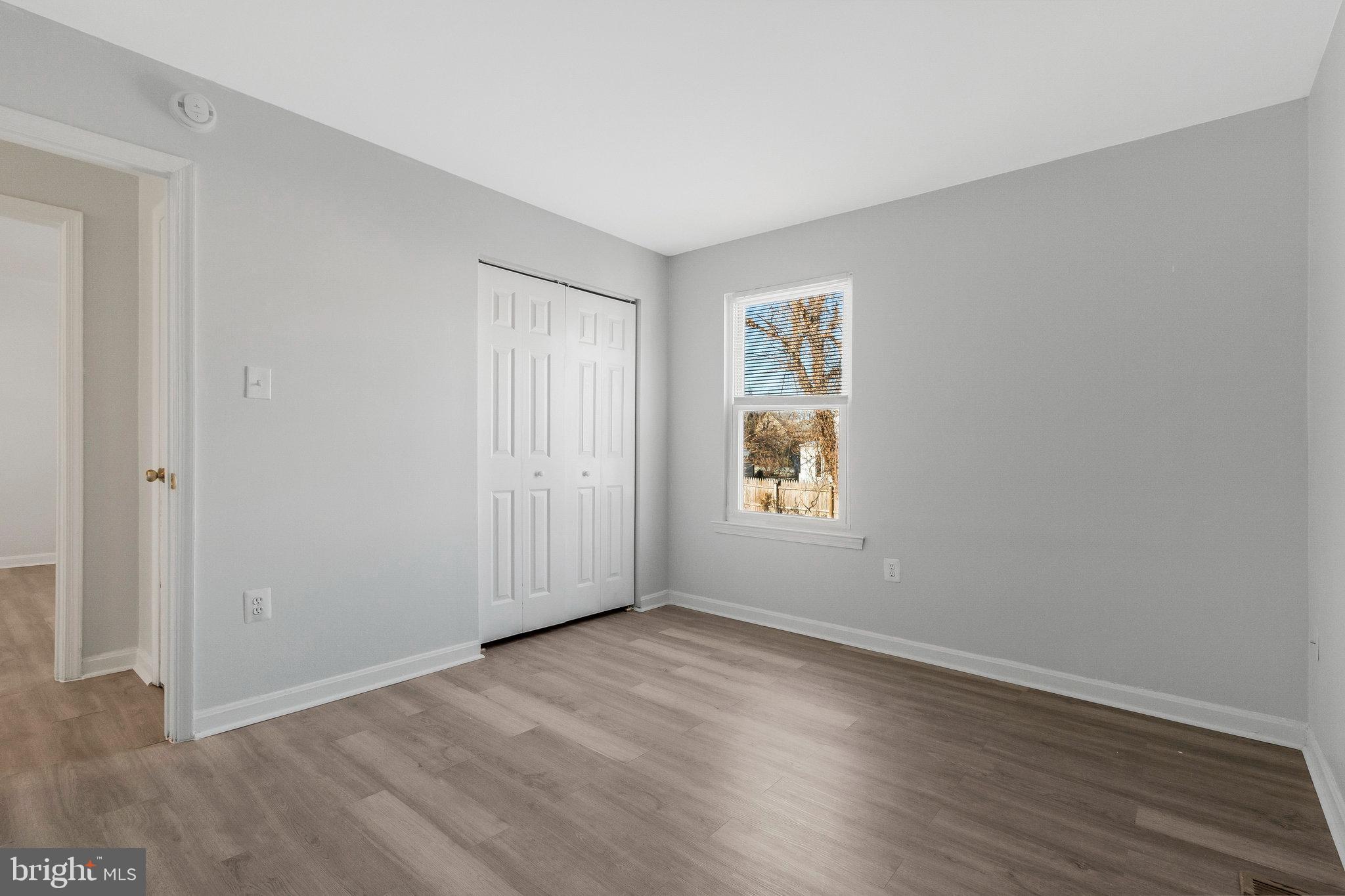 5004 Roanoke Place College Park, MD 20740 - Photo 13 of 27 an empty room with wooden floor and windows