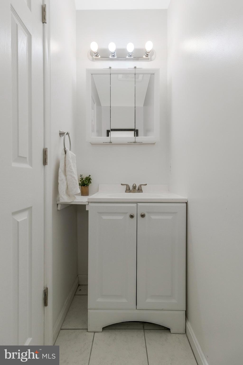 5004 Roanoke Place College Park, MD 20740 - Photo 14 of 27 a bathroom with a sink a vanity and mirror