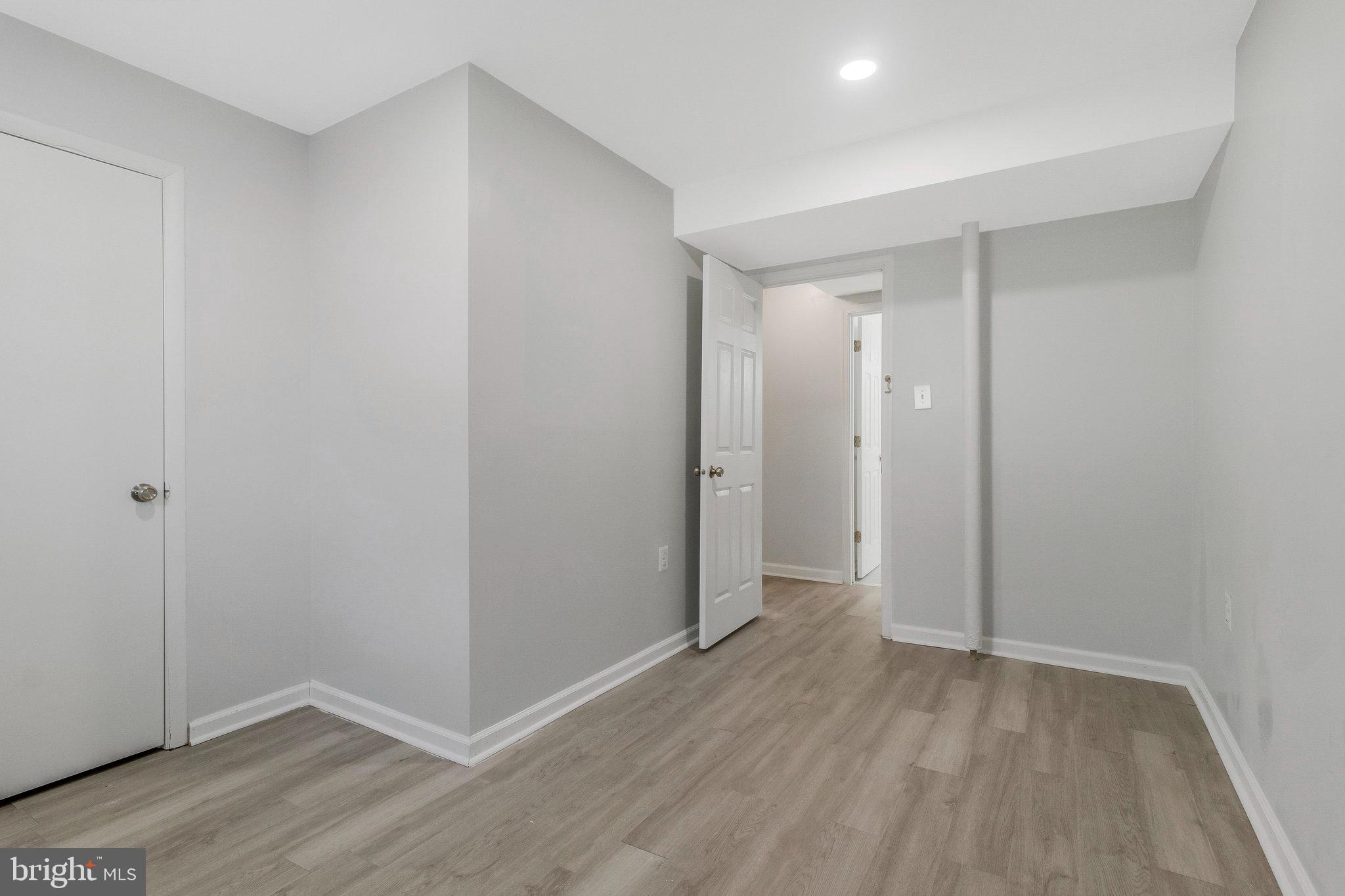 5004 Roanoke Place College Park, MD 20740 - Photo 17 of 27 a view of hallway with wooden floor