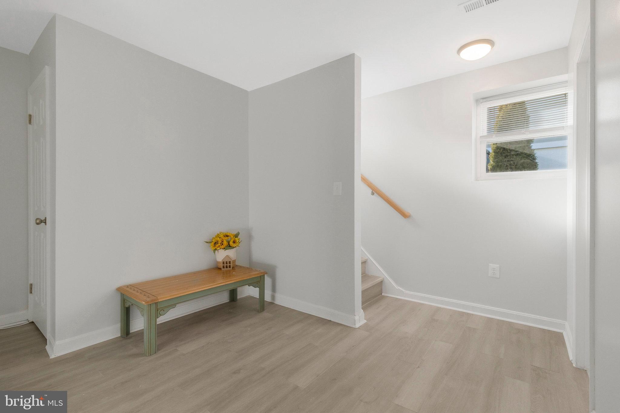 5004 Roanoke Place College Park, MD 20740 - Photo 22 of 27 a view of room with stairs and wooden floor