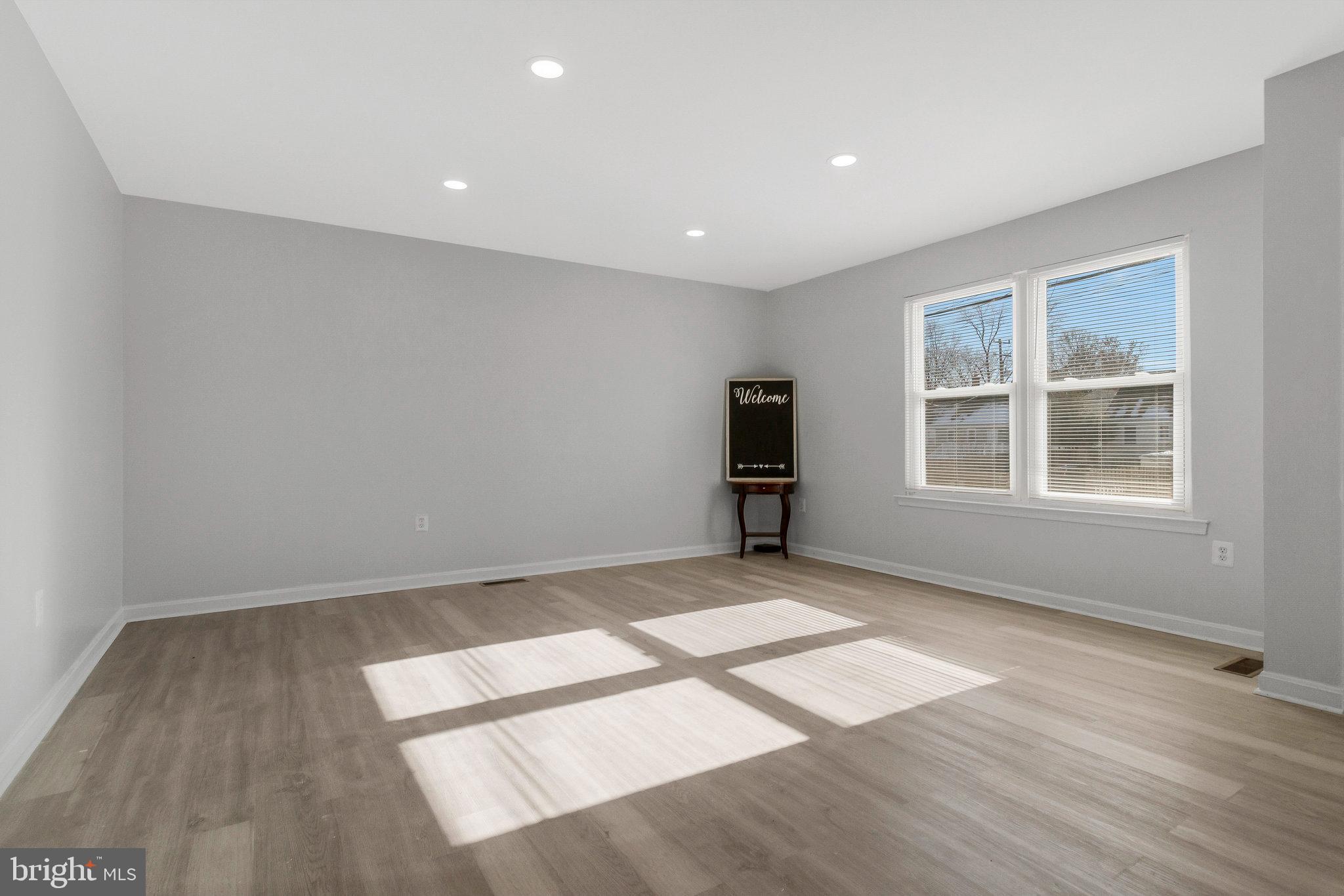 5004 Roanoke Place College Park, MD 20740 - Photo 4 of 27 an empty room with wooden floor and windows