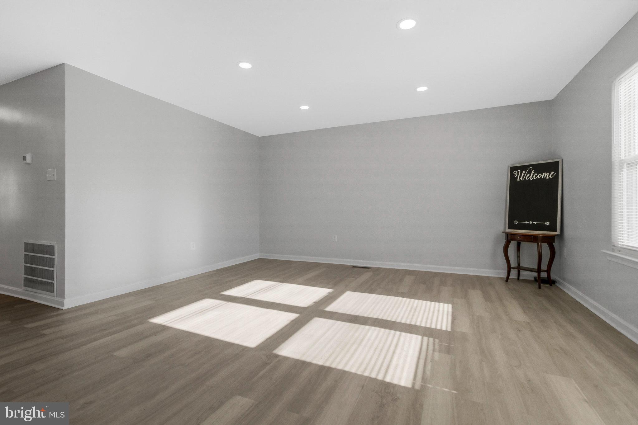 5004 Roanoke Place College Park, MD 20740 - Photo 5 of 27 wooden floor in an empty room with a window