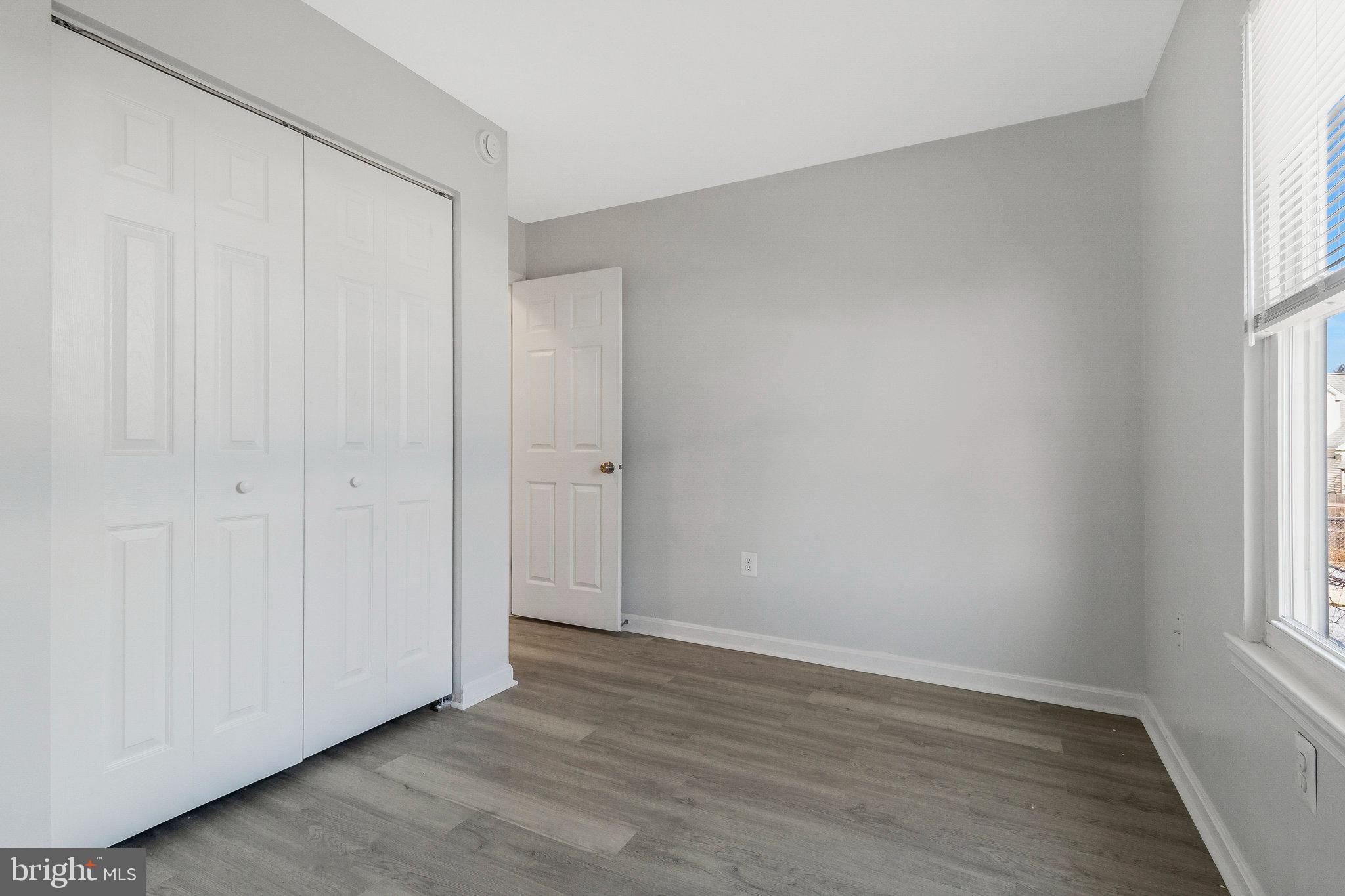 5004 Roanoke Place College Park, MD 20740 - Photo 7 of 27 an empty room with wooden floor and windows