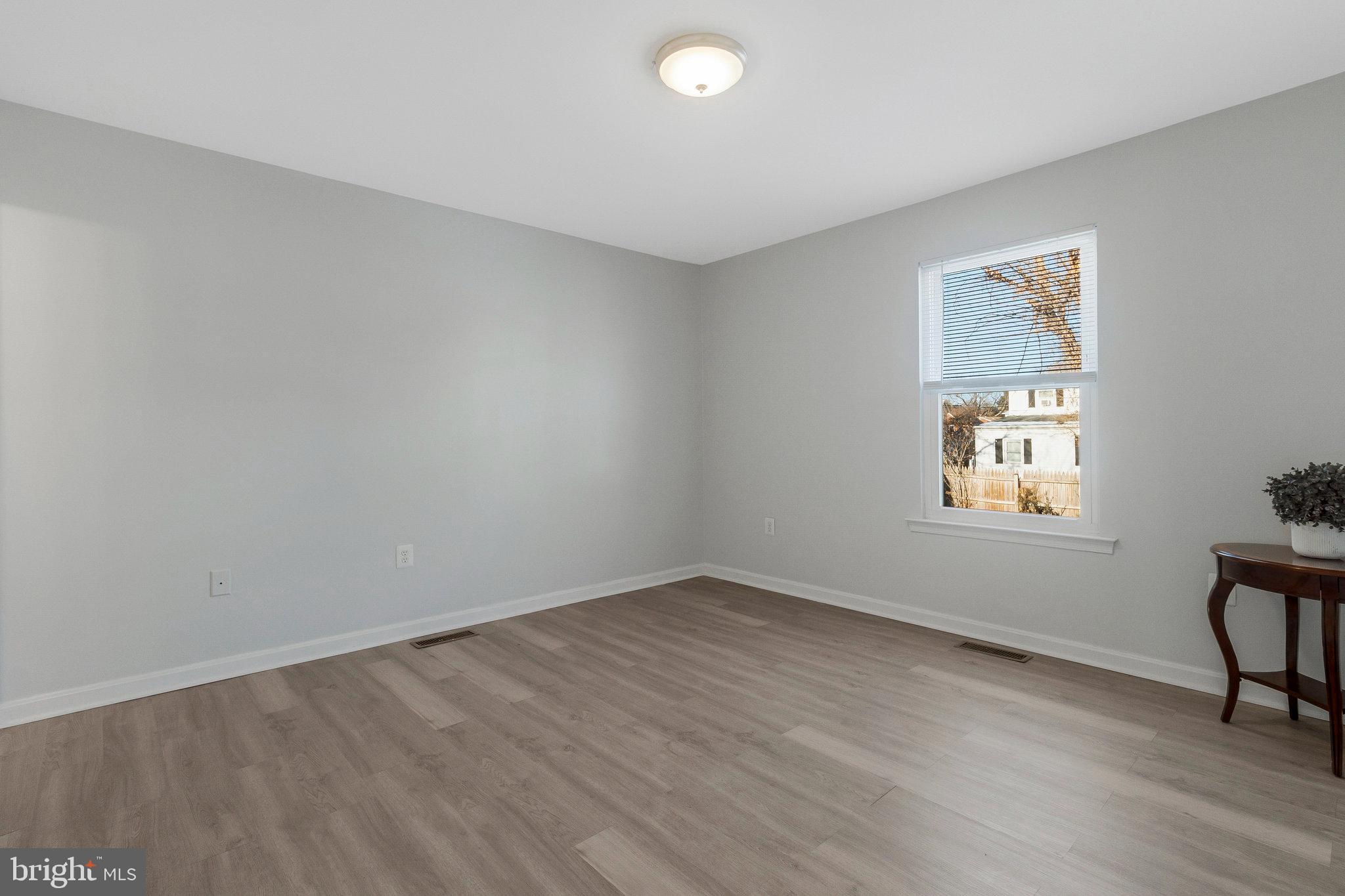 5004 Roanoke Place College Park, MD 20740 - Photo 9 of 27 wooden floor in an empty room with a window