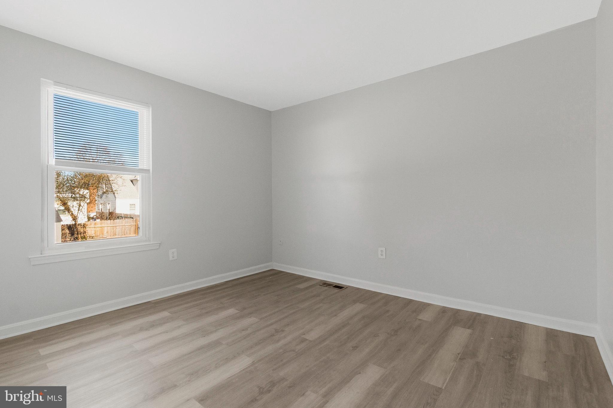 5004 Roanoke Place College Park, MD 20740 - Photo 10 of 27 wooden floor in an empty room with a window