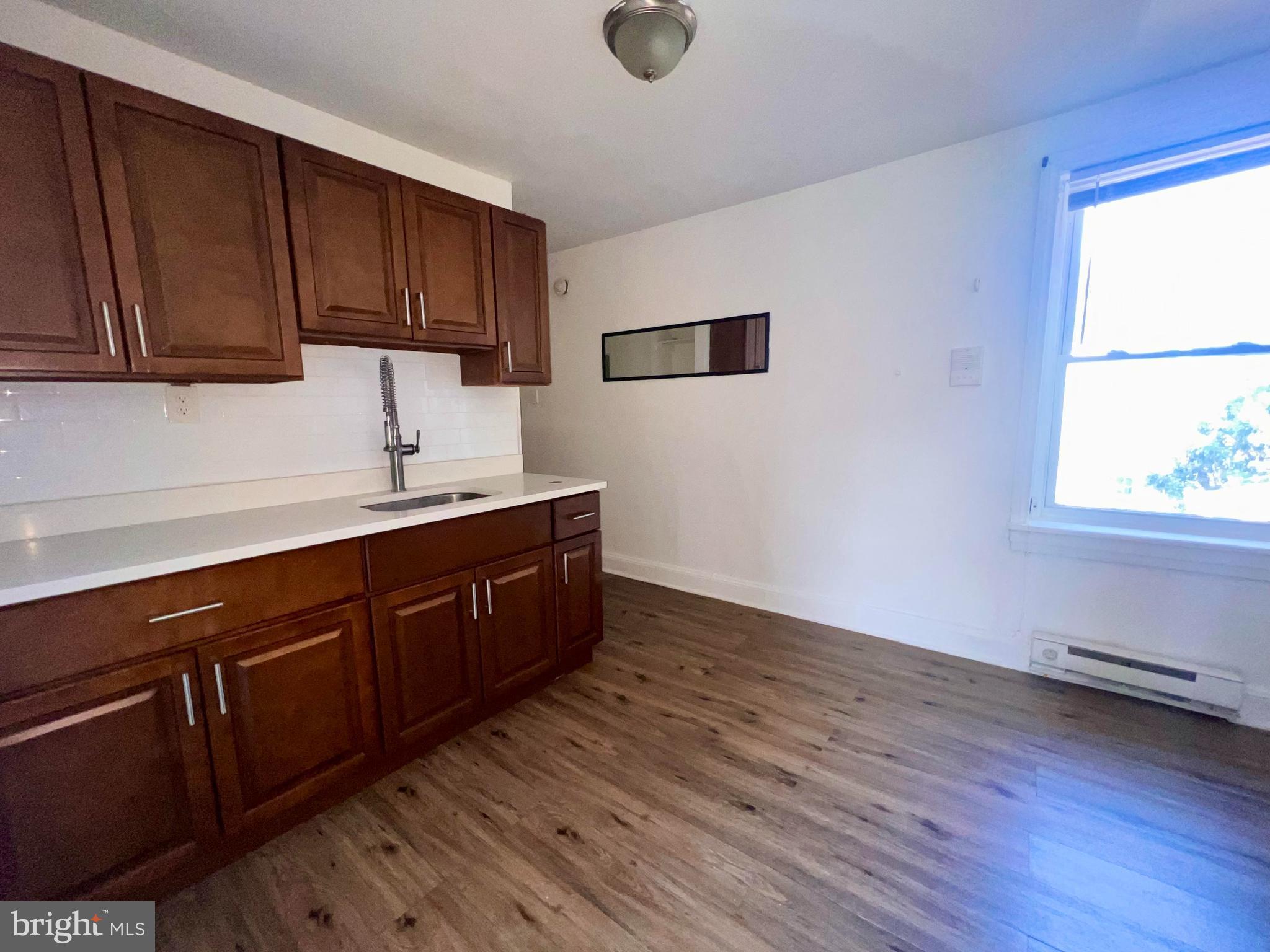 1249 Shackamaxon Street, Unit 3F Philadelphia, PA 19125 - Photo 4 of 12 a kitchen with wooden cabinets and sink