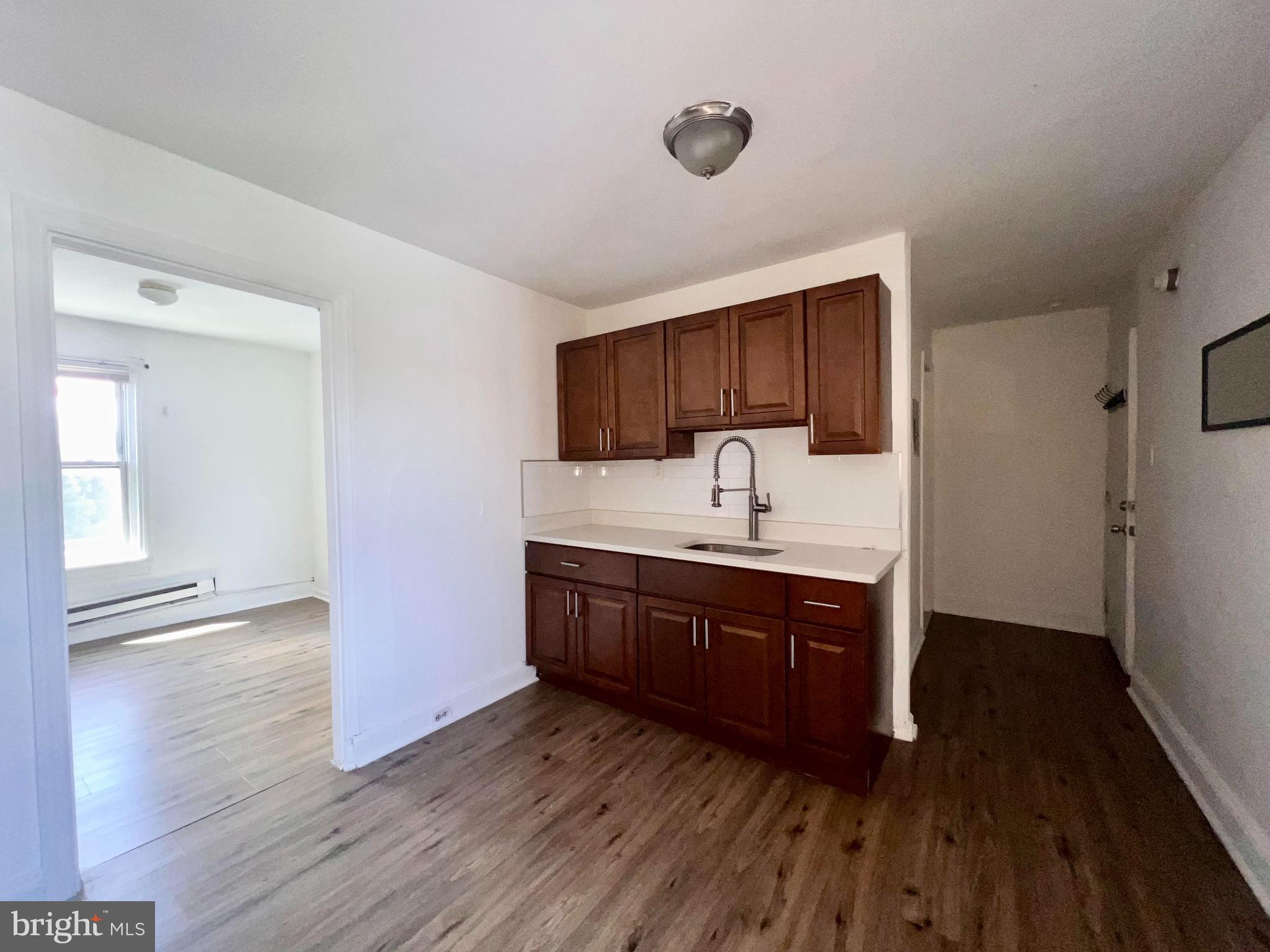 1249 Shackamaxon Street, Unit 3F Philadelphia, PA 19125 - Photo 5 of 12 a kitchen with stainless steel appliances granite countertop a sink stove and wooden floor
