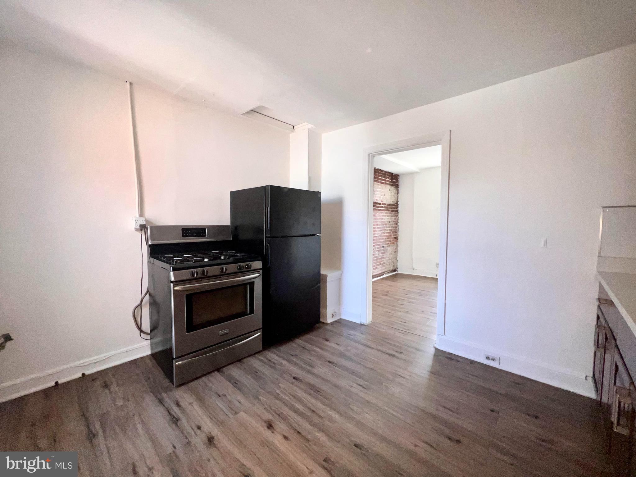 1249 Shackamaxon Street, Unit 3F Philadelphia, PA 19125 - Photo 6 of 12 a kitchen with wooden floors and appliances