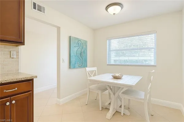 a dining room with furniture and window