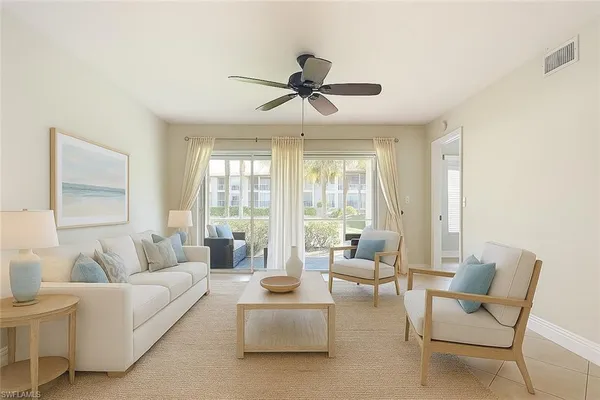 a living room with furniture and a large window