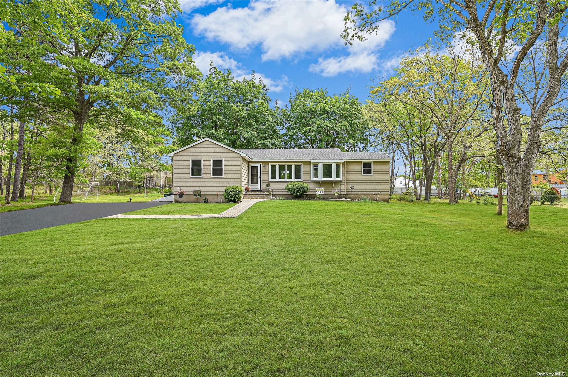 59 Old Saddle Road Ridge, NY 11961 - Photo 1 of 1 a front view of a house with a garden