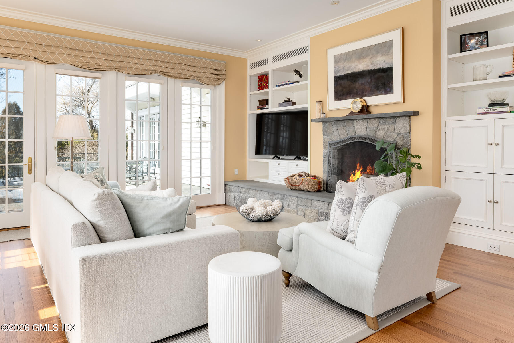 174 Round Hill Road Greenwich, CT 06831 - Photo 11 of 27 a living room with furniture a flat screen tv and a fireplace