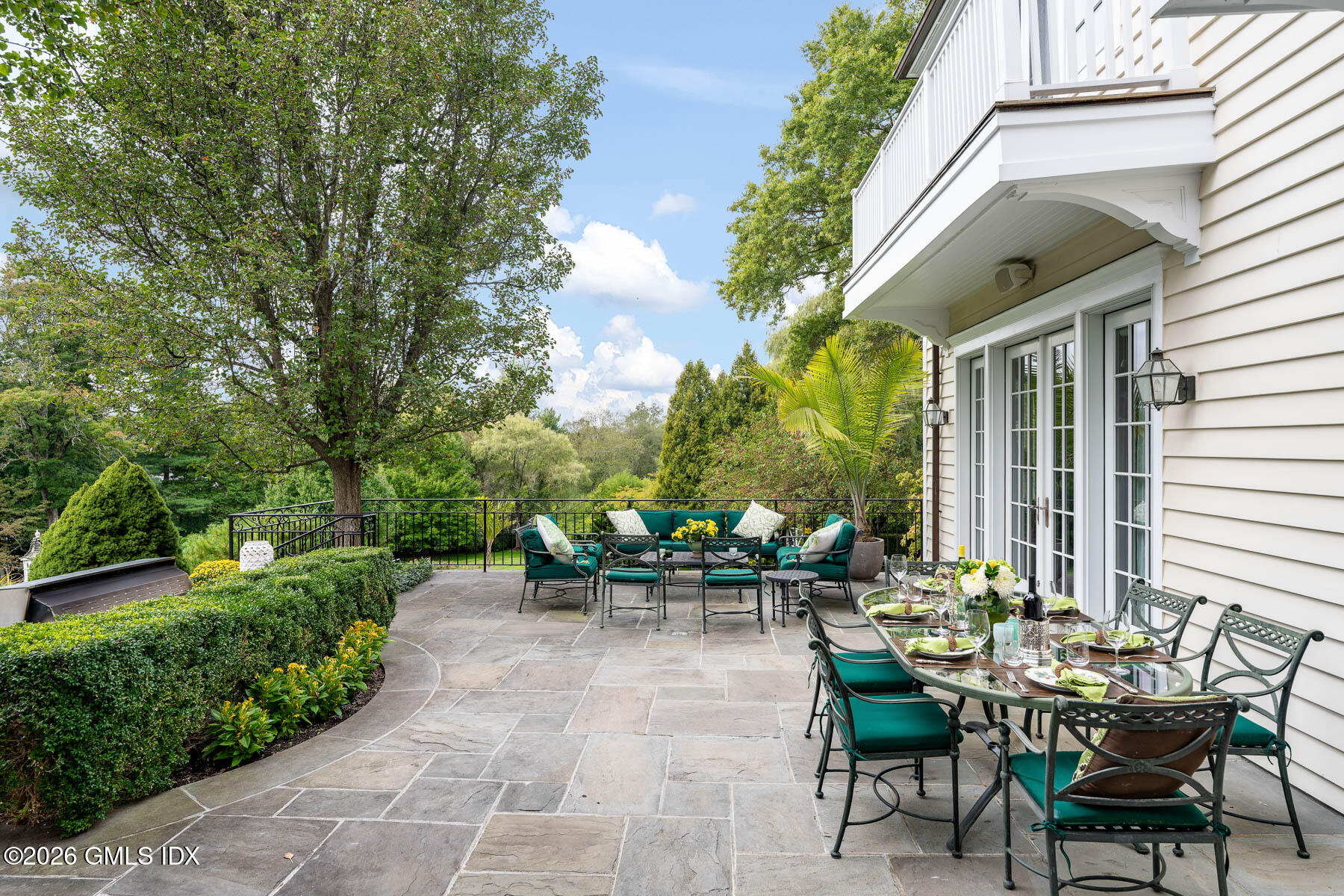 174 Round Hill Road Greenwich, CT 06831 - Photo 21 of 27 a view of a patio with table and chairs and potted plants
