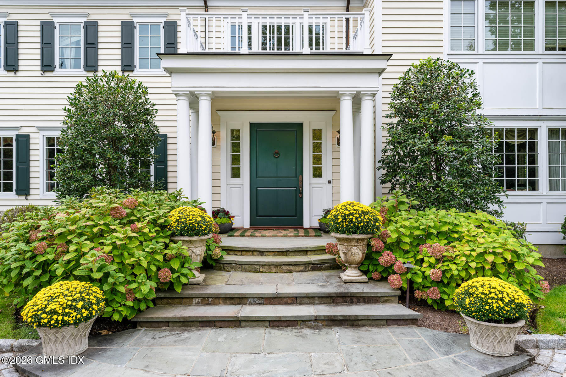174 Round Hill Road Greenwich, CT 06831 - Photo 5 of 27 a front view of a house with potted plants