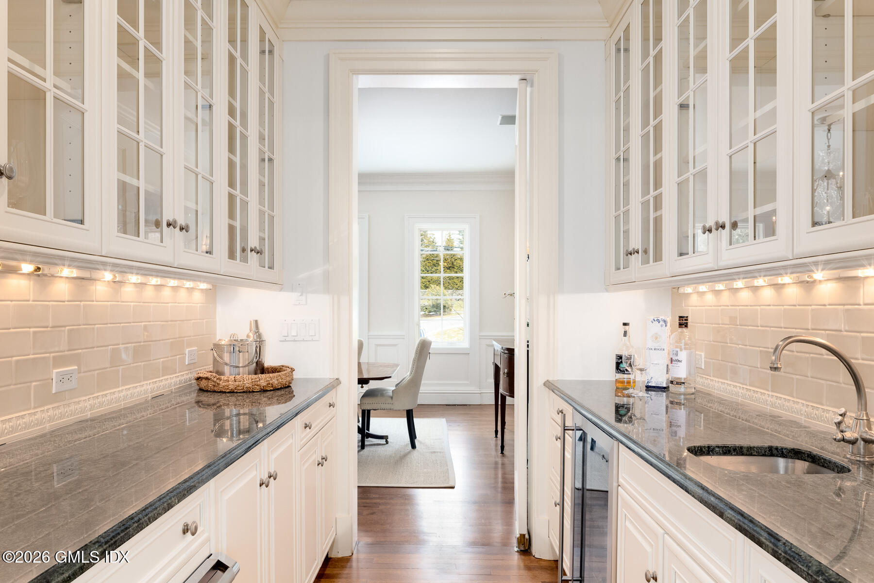 174 Round Hill Road Greenwich, CT 06831 - Photo 9 of 27 a kitchen with white cabinets and sink
