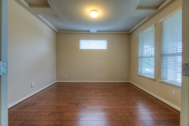 198 Stone View Trail Austin, TX 78737 - Photo 3 of 10 a view of an empty room with wooden floor and a window