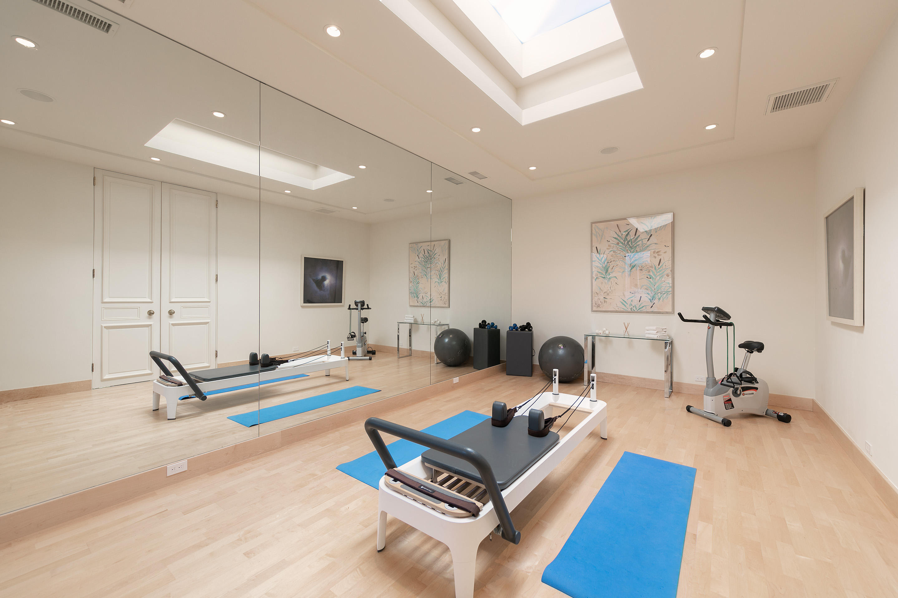 1188 East Mountain Drive Montecito, CA 93108 - Photo 35 of 44 a living room with furniture a wooden floor and gym equipment