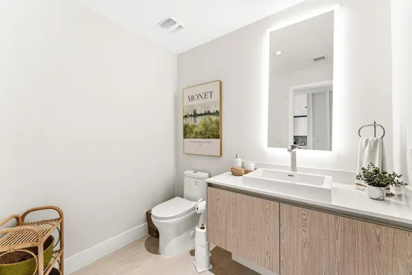 a bathroom with a toilet sink and mirror